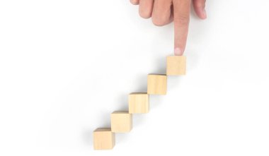 Business connecting piece of multi wood chart blocks steps in a hand