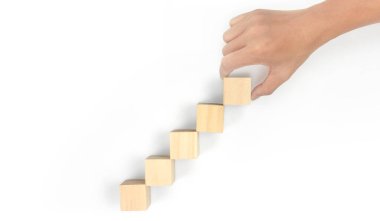 Business connecting piece of multi wood chart blocks steps in a hand