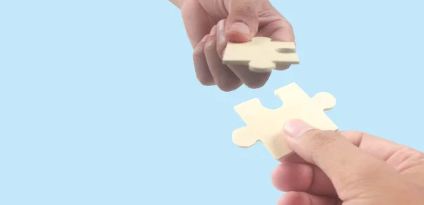 Connecting jigsaw puzzle in  hand. Business solutions success and strategy concept