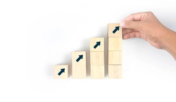 Business connecting piece of multi wood chart blocks steps in a hand