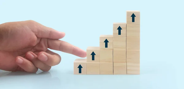 Business connecting piece of multi wood chart blocks steps in a hand