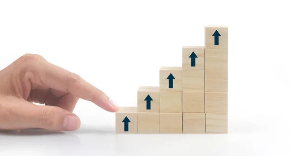 Business connecting piece of multi wood chart blocks steps in a hand