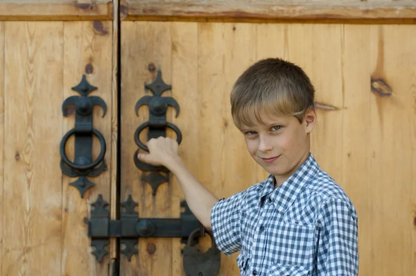 Niño cerca de la casa de madera — Foto de Stock