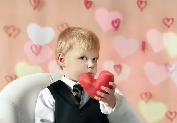 Valentine's Day - cute child with red Heart in hands. Royalty Free Stock Images