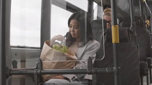 Medium Long Young Asian Woman Sitting Public Bus Carrying Paper — Stock Video