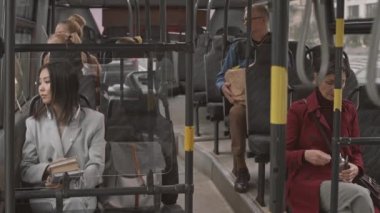 Gençler ve yaşlılar otobüse biniyor, gündüzleri oturuyor.