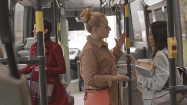 Medium Asian Woman Holding Books Caucasian Female Companion Standing Bus — Stock Video