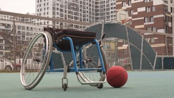 Low Angle Locked Wheelchair Outdoor Basketball Court Ball Rolling Frame — Stock Video