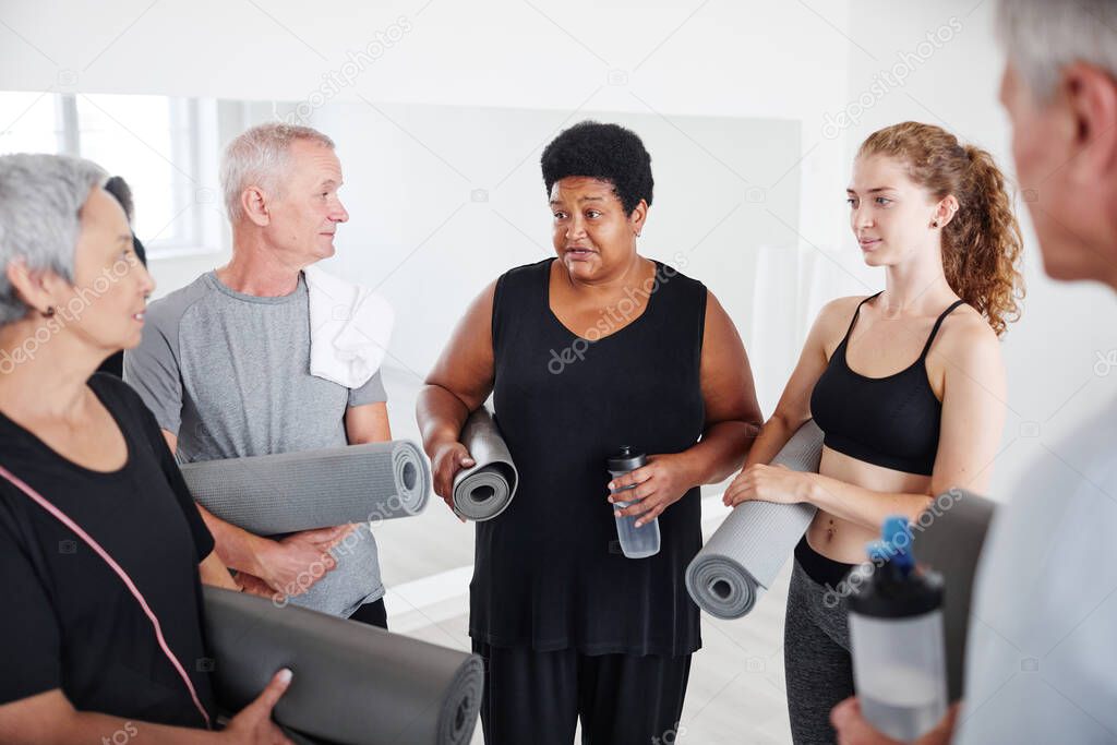 People discussing yoga training