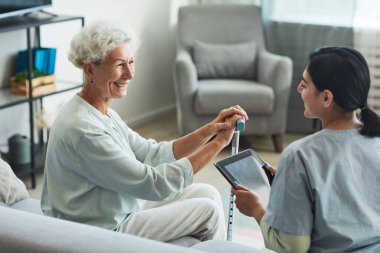 Nurse Talking to Senior Woman in Retirement Home clipart