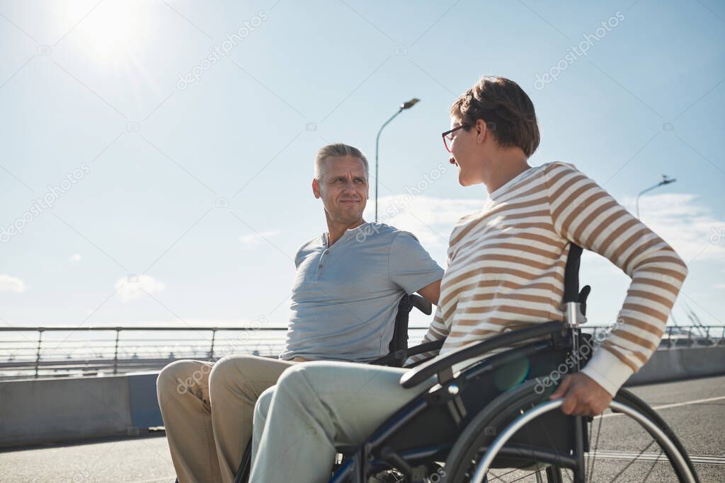 Adult Couple in Wheelchairs Outdoors
