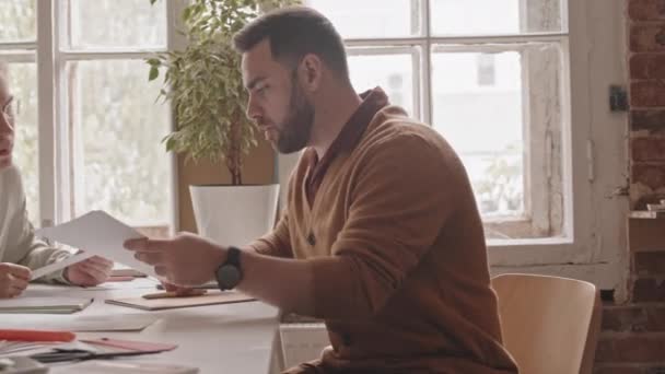 Panning Medium Slowmo Shot Two Young Male Architects Sitting Table — Stock video