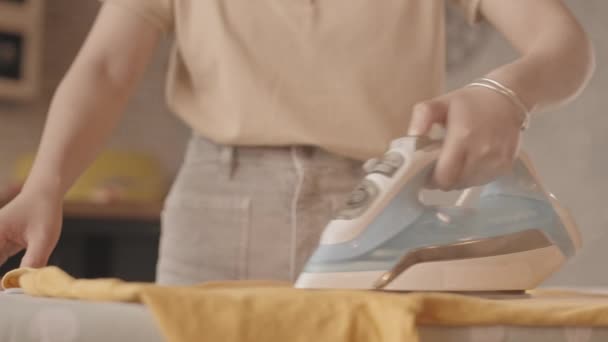 Slowmo Close Unrecognizable Woman Ironing Mustard Shirt Ironing Board Home — Stock Video