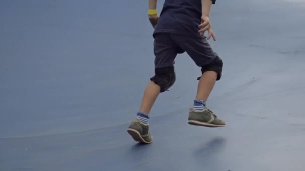 Отслеживающий Снимок Игривого Семилетнего Кавказского Мальчика Коленях Локтях Скользящего Катку — стоковое видео