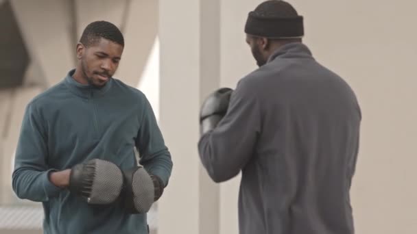 Medium Slowmo Shot Two Sportive Black Men Wearing Boxing Pads — Stock Video