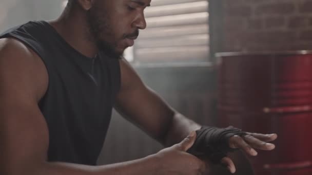 Medium Close Slowmo Muscular Black Man Wrapping Hands Bandage Putting — Stock Video
