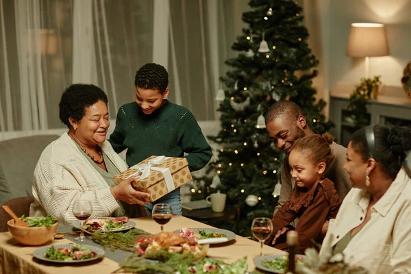 Senior Woman Opening Christmas Present — Stock Photo, Image