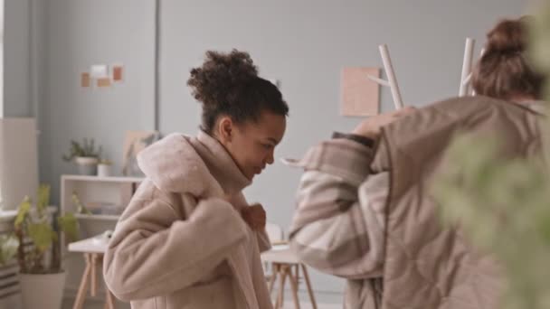 Medium Slowmo Shot Two Young Female Colleagues Taking Hanging Jackets — Stock Video