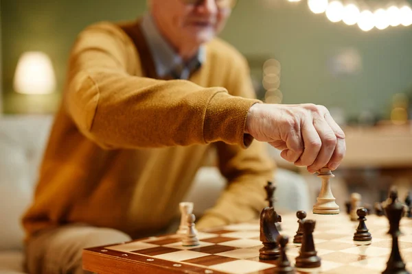 Senior man holding chess piece — Stock Photo, Image