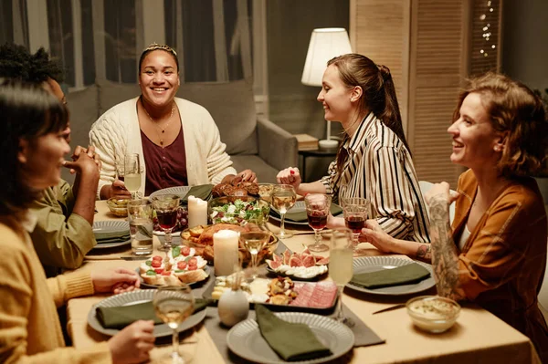 Amigos sentados à mesa de jantar em casa — Fotografia de Stock