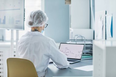 Researcher using laptop at her work