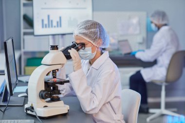 Woman holding research at the laboratory