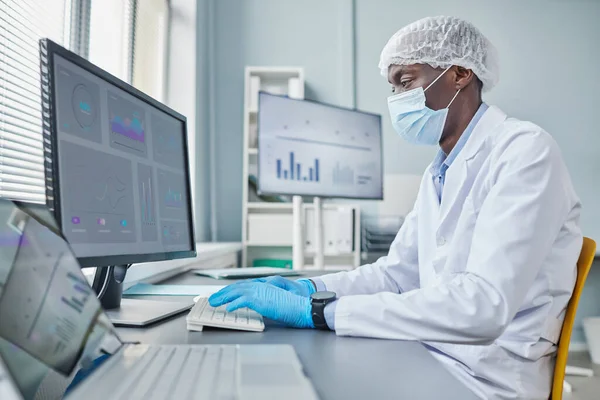 Chemist working on computer at office