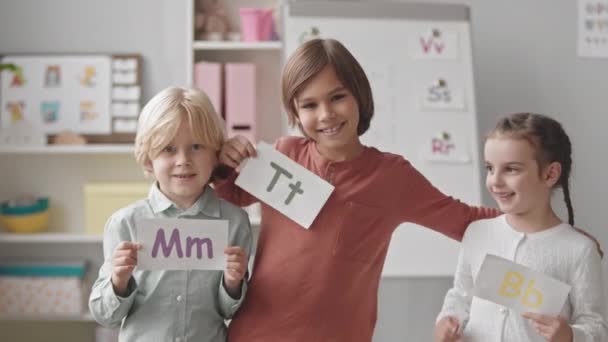 Medium Portrait Three Cheerful Caucasian Children Elementary Age Posing Camera — Stockvideo