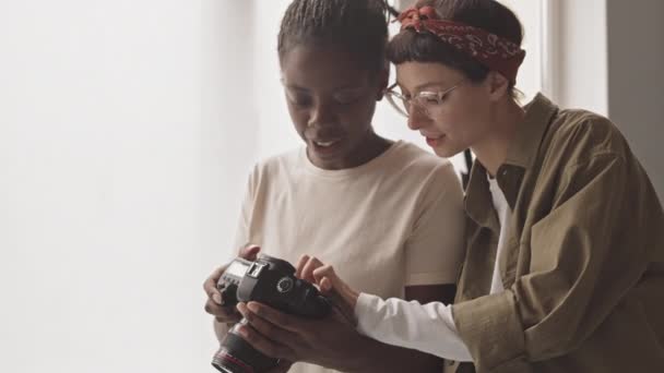 Medium Shot Two Young Multiethnic Female Photographers Looking Photos Taken — Stok video