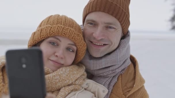 Medium Closeup Slowmo Young Happy Caucasian Couple Taking Winter Selfie — Stok video