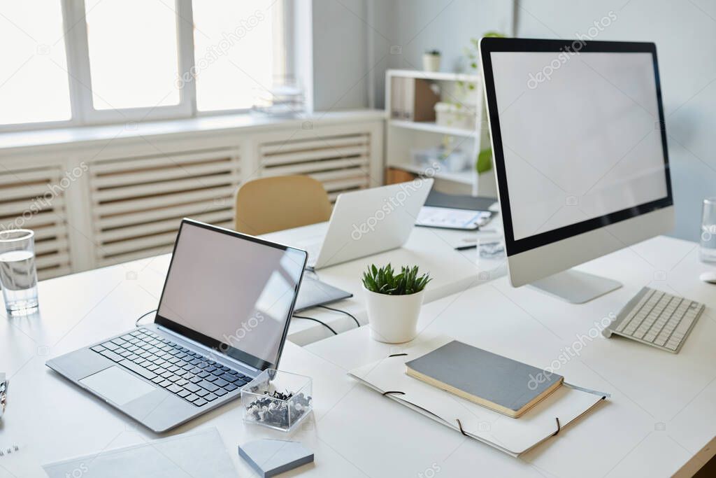 Background image of office workplace with two mock up computer screens on white desk, copy space
