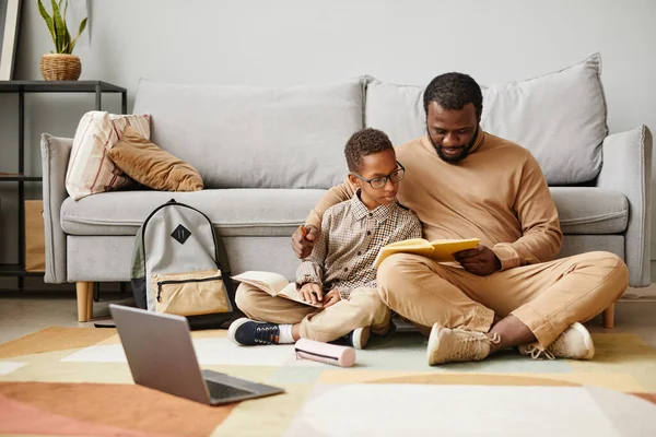 Father and Son Reading Book on Floor — Stock Photo, Image