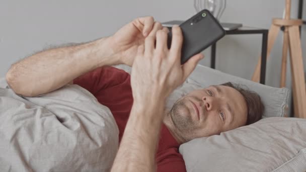 Slowmo Shot Sleepy Young Caucasian Man Scrolling Smartphone Whilst Lying — Stock Video
