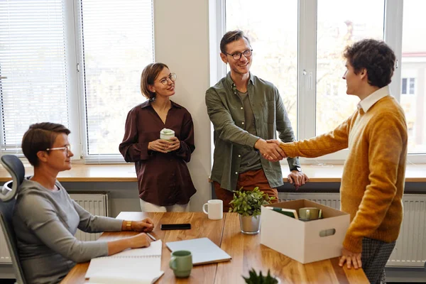 Colleagues Welcoming New Employee