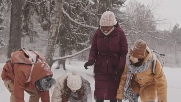 Média Lentidão Tiro Quatro Amigos Multiétnicos Alegres Jogando Neve Abraçando — Vídeo de Stock