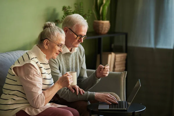 Mujer mayor contemporánea con su marido compras en línea — Foto de Stock