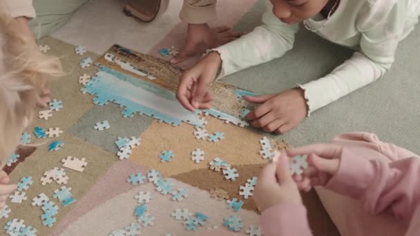Draufsicht Vorschulkinder Lösen Der Freizeit Gemeinsam Puzzle Auf Dem Fußboden — Stockvideo