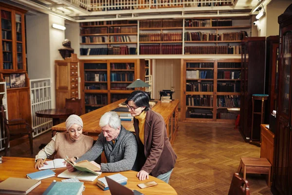 Люди навчаються в бібліотеці — стокове фото