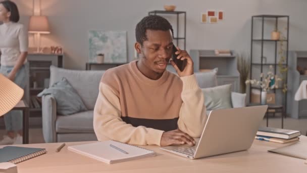 Medium Slowmo African American Businessman Making Phone Call Working Laptop — Stock Video