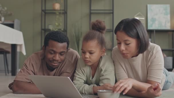 아프리카 미국인 아이와 사랑하는 거실의 양탄자 컴퓨터로 영화를 느림보로 생각해 — 비디오