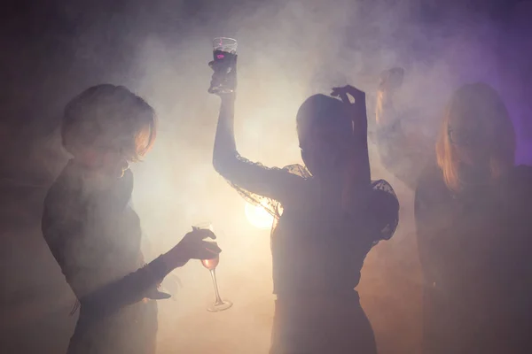 Foto Retroiluminada Mujeres Jóvenes Bailando Fiesta Siluetas Elegantes Club Ahumado — Foto de Stock