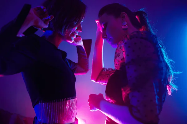 Cropped Shot Two Young Women Dancing Together Club Lit Pink — Stock Photo, Image