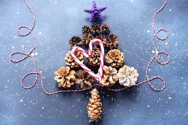 Christmas Tree Made Pine Cones Blue Background Sparkles New Year — Φωτογραφία Αρχείου