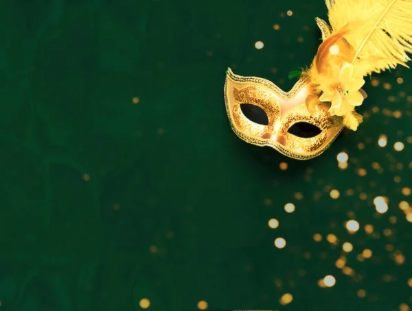 Masquerade mask on dark background with sparkles. The concept of traditional holidays. Close-up, copy space