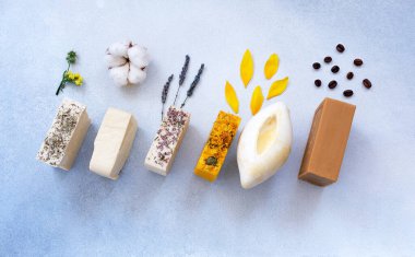 Organic natural set of calendula, lavender, natural and herbal of soap on light colors background. Handmade organic soap concept from natural ingredients. Close-up, top view