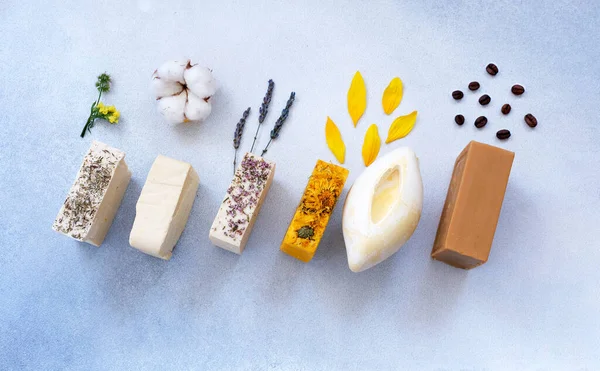 Organic natural set of calendula, lavender, natural and herbal of soap on light colors background. Handmade organic soap concept from natural ingredients. Close-up, top view