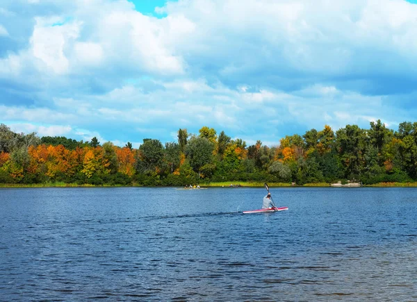 Man is kayaking on the river. The concept of outdoor activities. Autumn mood.