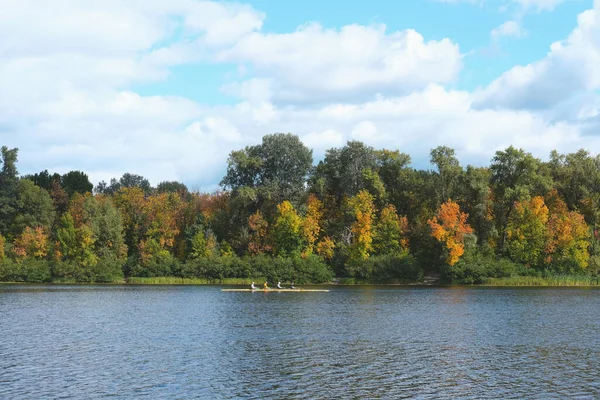 Young men are training to swim in kayaks on the river. Preparation for competitions or outdoor activities.