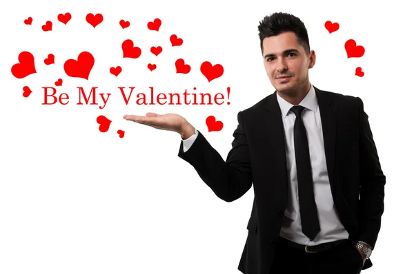 Handsome guy sending love in the shape of red hearts — Stock Photo, Image