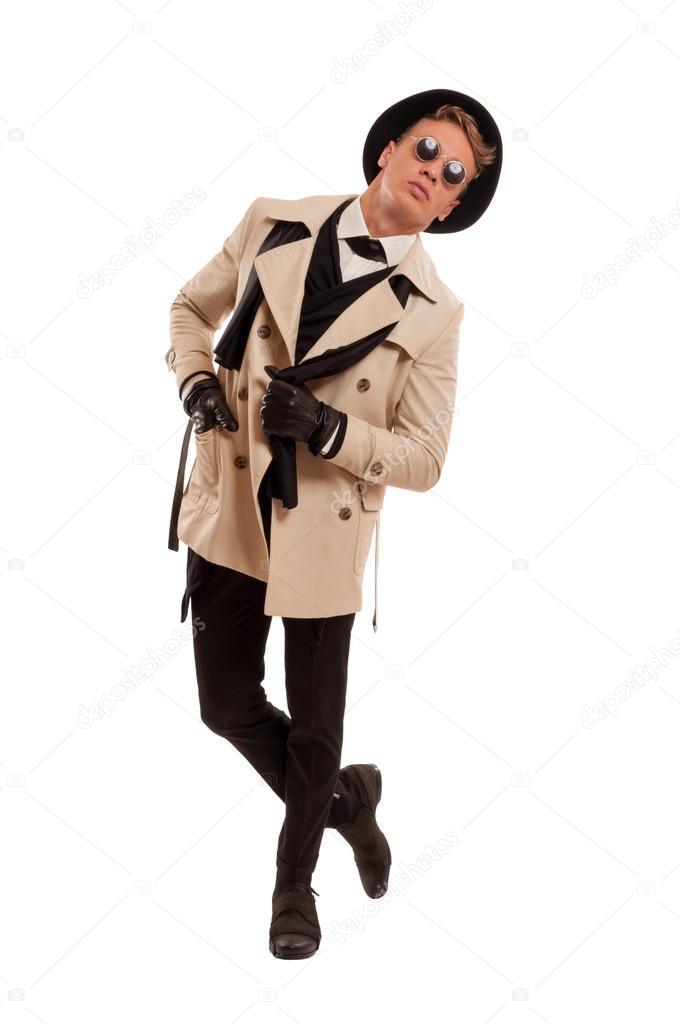 Fashion detective undercover posing on a white backgroun